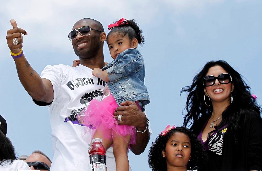 File photo of Los Angeles Lakers star Kobe Bryant carrying his daughter Gianna, as his wife Vanessa and daughter Natalia (second right) stand next to him during the NBA Championship parade in Los Angeles June 21, 2010. u00e2u20acu201d Reuters pic
