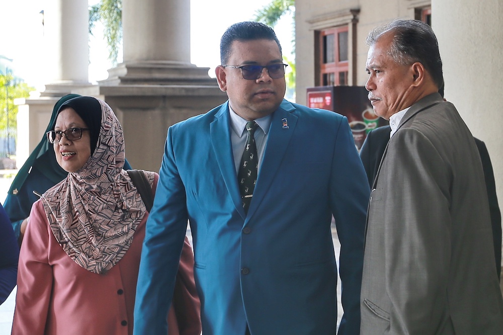 Datuk Lokman Noor Adam (green suit) is pictured at the Kuala Lumpur High Court January 9, 2020. u00e2u20acu201d Picture by Ahmad Zamzahuri