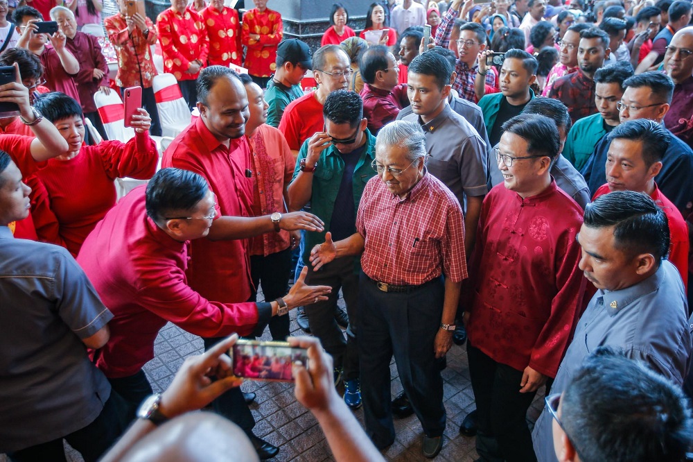 Prime Minister Tun Dr Mahathir Mohamad (centre) arrives for the Chinese New Year Open House hosted by Gerakan at the PGRM Tower in Kuala Lumpur January 25, 2020. u00e2u20acu201d Picture by Hari Anggara
