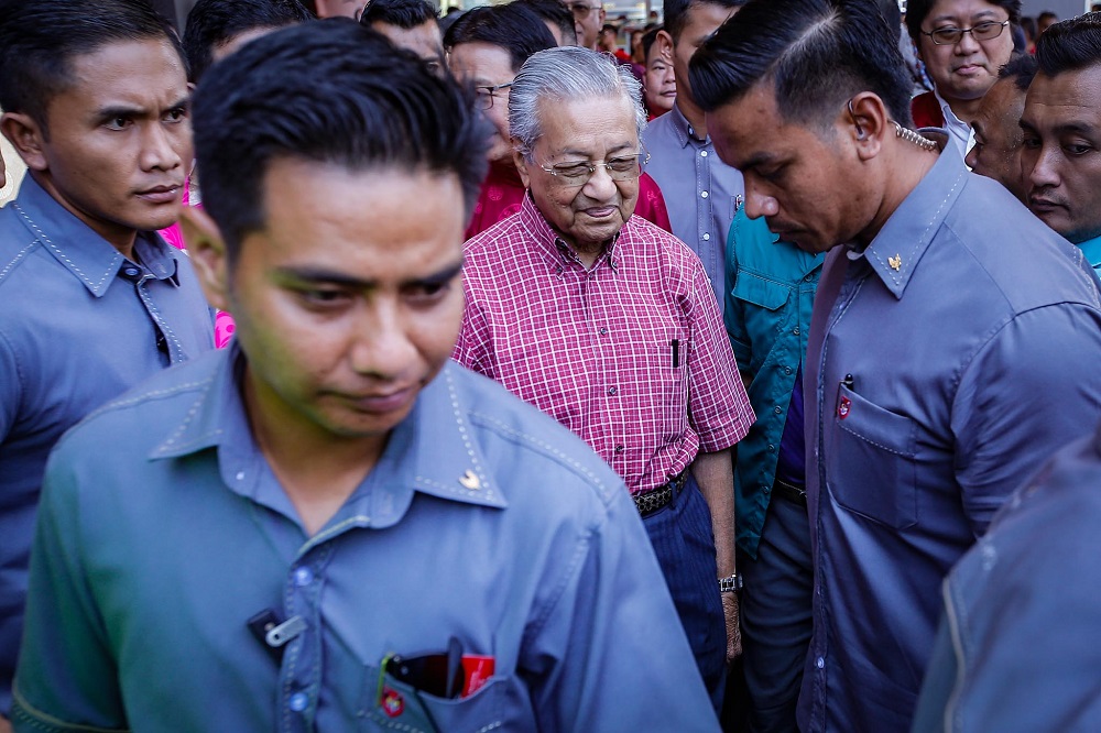 Prime Minister Tun Dr Mahathir Mohamad (centre) leaves after attending the Chinese New Year Open House hosted by Gerakan at the PGRM Tower in Kuala Lumpur January 25, 2020. u00e2u20acu201d Picture by Hari Anggara