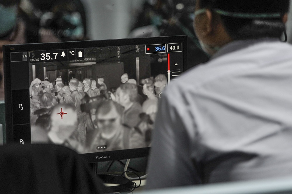 A health quarantine officer stationed at a thermal screening point monitors passengers at the international arrival terminal of the Kuala Lumpur International Airport in Sepang January 27, 2020. u00e2u20acu201d Picture by Shafwan Zaidon