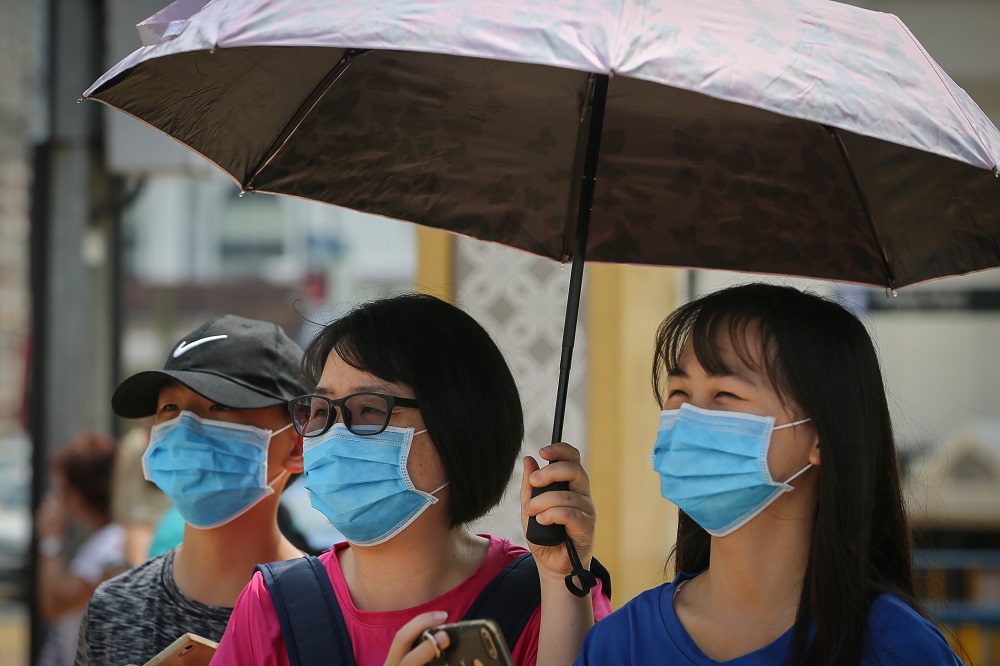 Chinese tourists wearing protective face masks are seen at the Dataran Merdeka in Kuala Lumpur January 28, 2020. u00e2u20acu201d Picture by Yusof Mat Isa