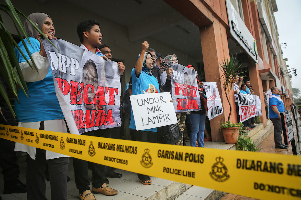 Party Keadilan Rakyat members who are against PKR vice-president Zuraida Kamaruddin hold banners and shout slogans as they gather outside the party headquarters in Petaling Jaya January 29, 2020. u00e2u20acu201d Picture by Yusof Mat Isa