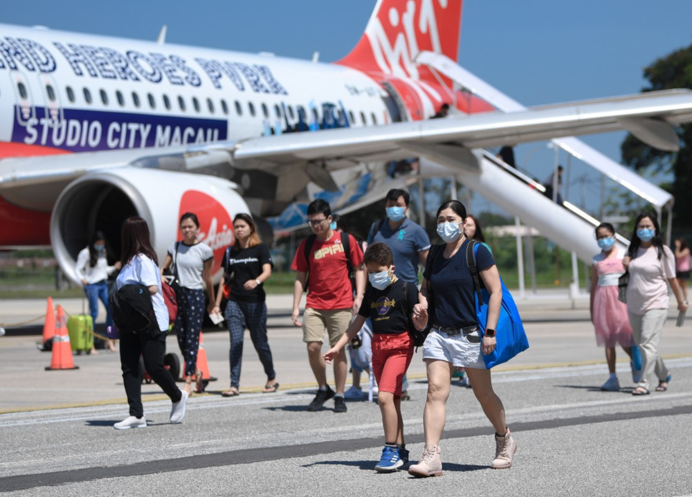 Travellers from Singapore wear face masks at the the Sultan Azlan Shah airport in Ipoh, January 24, 2020. u00e2u20acu201d Bernama pic