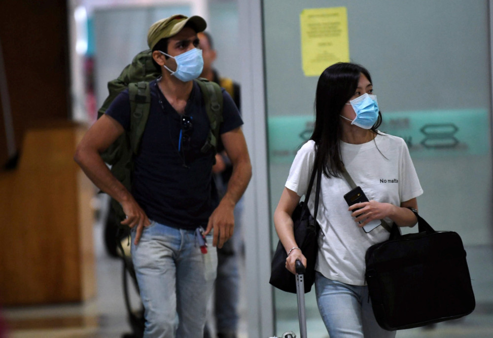 Tourists wear masks upon arrival at the Kota Kinabalu International Airport following the coronavirus infection January 24, 2020. u00e2u20acu201d Bernama pic  