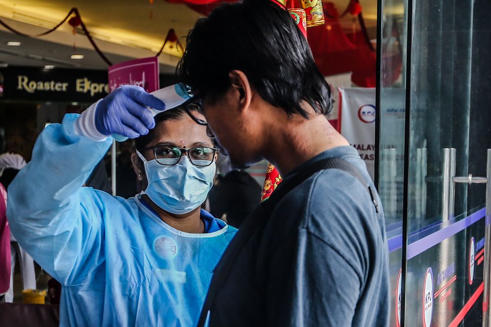 Medical personnel check the temperature of a visitor at the entrance of KPJ Tawakkal hospital in Kuala Lumpur, January 28, 2020. u00e2u20acu201d Picture by Firdaus Latif