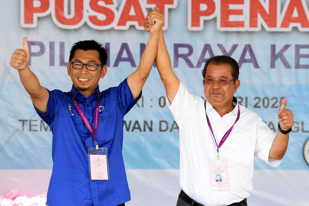 BN candidate Datuk Mohamad Alamin and Warisan candidate Datuk Karim Bujang pose for pictures on Nomination Day at Dewan Datuk Seri Panglima Dun Banir in Beaufort January 4, 2020. u00e2u20acu2022 Bernama pic