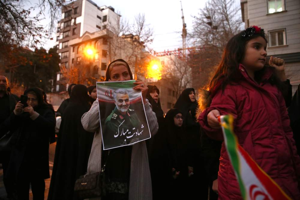 An Iranian demonstrator holds a picture of the late Iranian Major-General Qassem Soleimani, during a protest in front of United Nation office in Tehran, Iran January 3, 2020. u00e2u20acu2022 Reuters pic