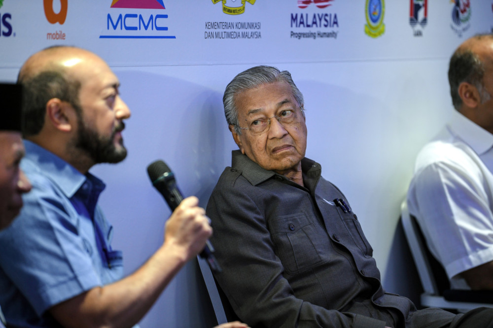 Prime Minister Tun Dr Mahathir Mohamad listens to a question from Kedah Mentri Besar Datuk Seri Mukhriz Mahathir to Telekom Malaysia Bhdu00e2u20acu2122s Chief Strategy Officer Tengku Muneer Tengku Muzani during a visit to the 5G Demonstration Project in Langkawi Janu