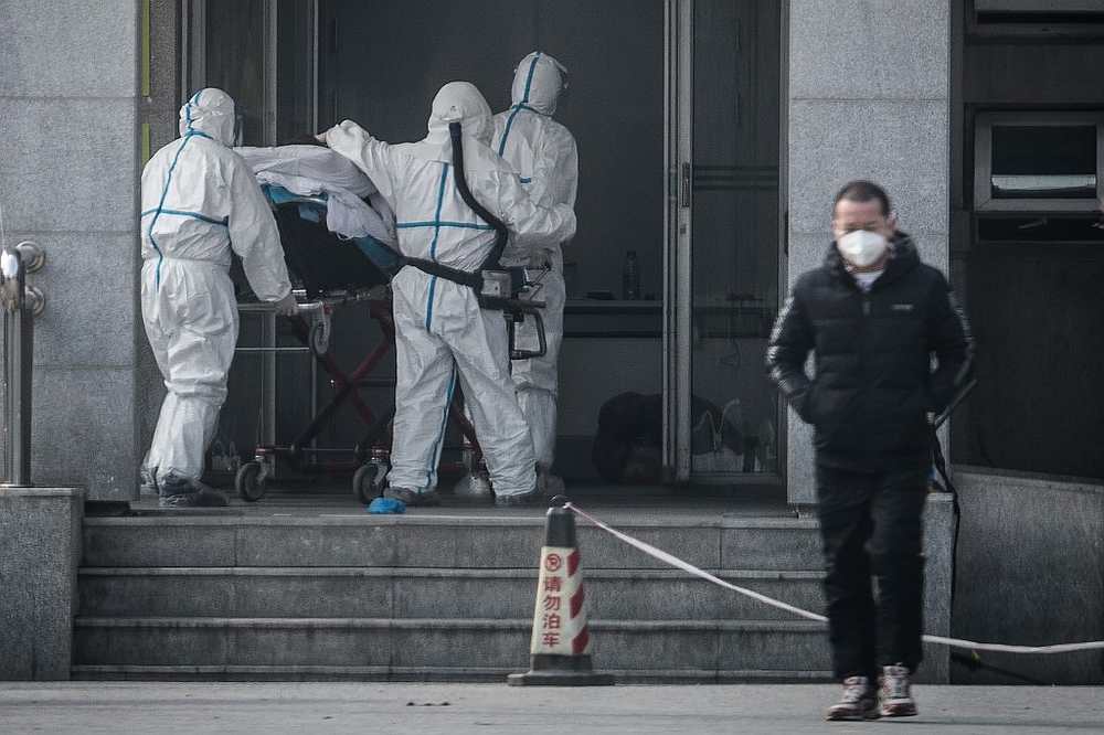 Medical staff members carry a patient into the Jinyintan hospital, where patients infected by a mysterious SARS-like virus are being treated, in Wuhan in China's central Hubei province January 18, 2020. u00e2u20acu201d AFP pic