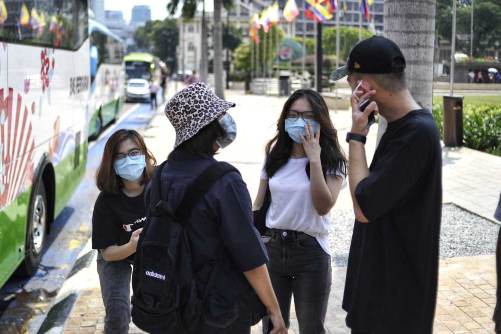Tourists are seen wearing masks to protect themselves against the new coronavirus in Kuala Lumpur January 26, 2020. u00e2u20acu2022 Picture by Shafwan Zaidon