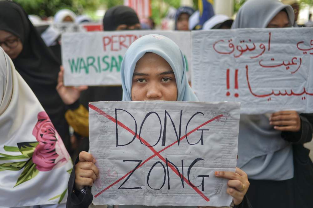 Protesters hold placards as they staged a peaceful protest in Kuala Lumpur January 1, 2020. u00e2u20acu2022 Picture by Shafwan Zaidon  