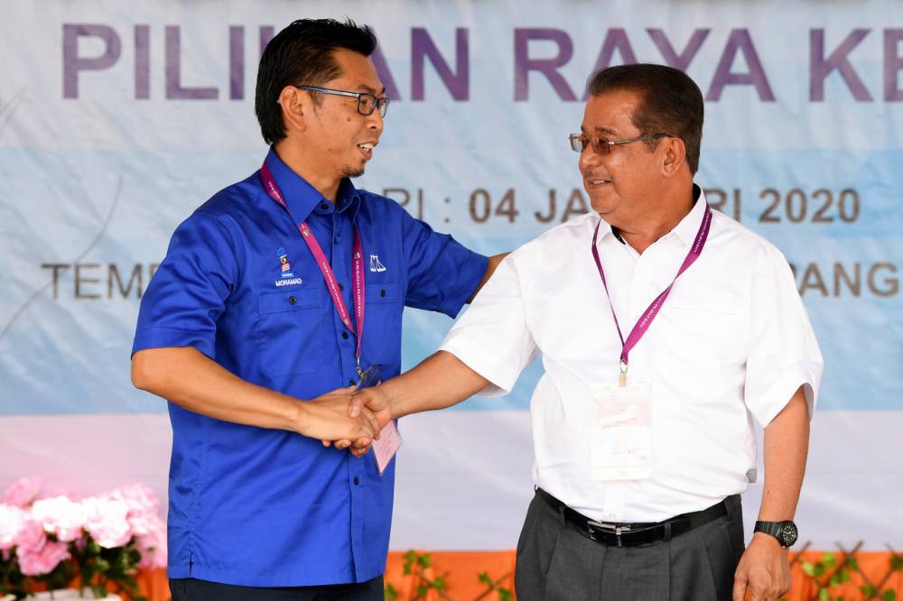 Warisan candidate Datuk Karim Bujang (right) shakes hands with BN candidate Datuk Mohamad Alamin at the Dewan Datuk Seri Panglima Dun Banir in Beaufort January 4, 2020. u00e2u20acu2022 Bernama pic