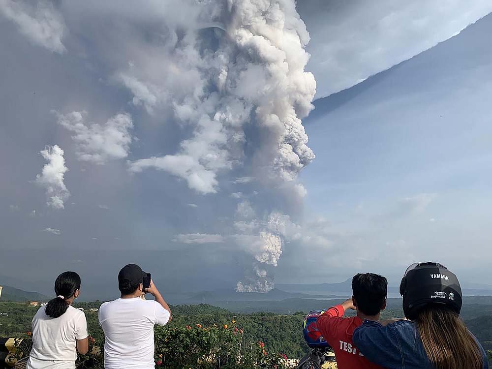 People take photos of a phreatic explosion from the Taal volcano as seen from the town of Tagaytay in Cavite province, southwest of Manila January 12, 2020. u00e2u20acu201d AFP pic