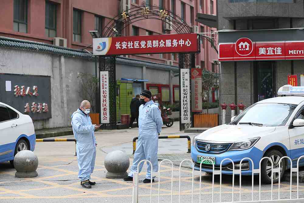 Taxi drivers in protective suits are seen in front of a residential area, following an outbreak of the new coronavirus and the cityu00e2u20acu2122s lockdown, in Wuhan, Hubei province, China January 28, 2020. u00e2u20acu201d China Daily pic via  Reuters
