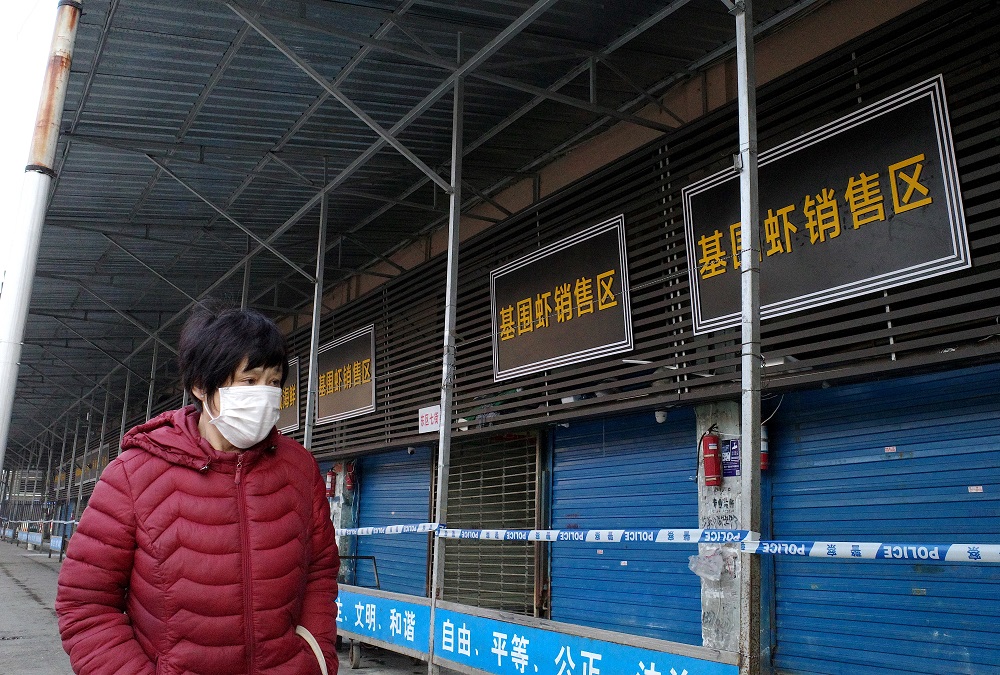 In this file photograph taken on January 12, 2020, a woman walks in front of the closed Huanan Seafood Market, where health authorities say a man who died from a respiratory illness had purchased goods from, in the city of Wuhan, Hubei province. u00e2u20acu201d AFP p