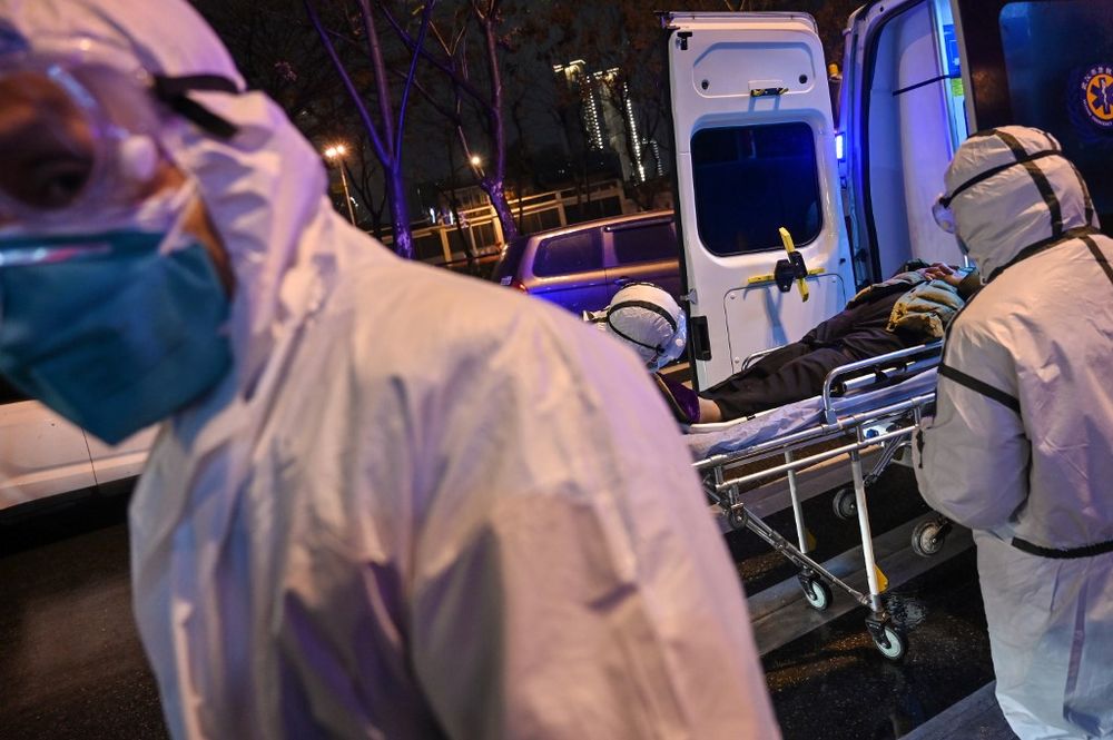 In this photo taken on January 25, 2020, medical staff wearing protective clothing to protect against a previously unknown coronavirus arrive with a patient at the Wuhan Red Cross Hospital in Wuhan. u00e2u20acu201d AFP pic