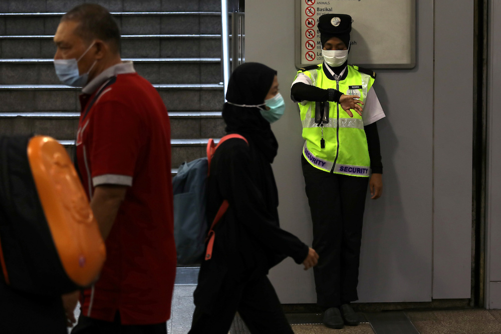 A security guard wearing a mask looks at her watch at a Light Rail Transit station in Kuala Lumpur January 31, 2020. u00e2u20acu201d Reuters pic