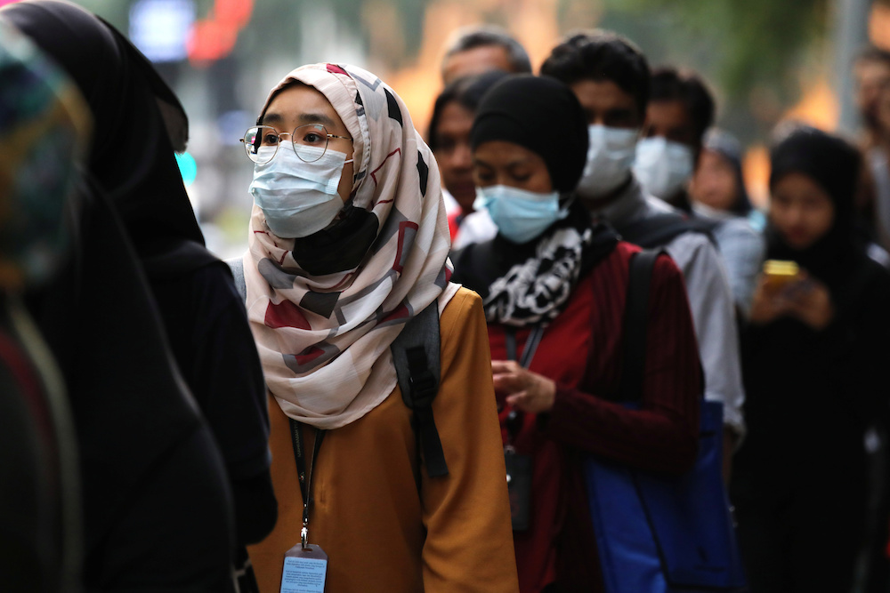 Passengers wear masks at a bus station in Kuala Lumpur January 31, 2020. u00e2u20acu201d Reuters pic