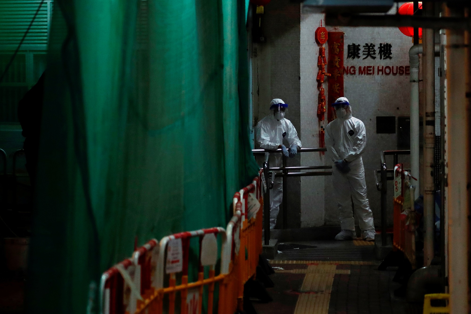 Personnel in protective gear prepare to evacuate residents from a public housing building following the outbreak of the novel coronavirus, in Hong Kong, China February 11, 2020. REUTERS/Tyrone Siu