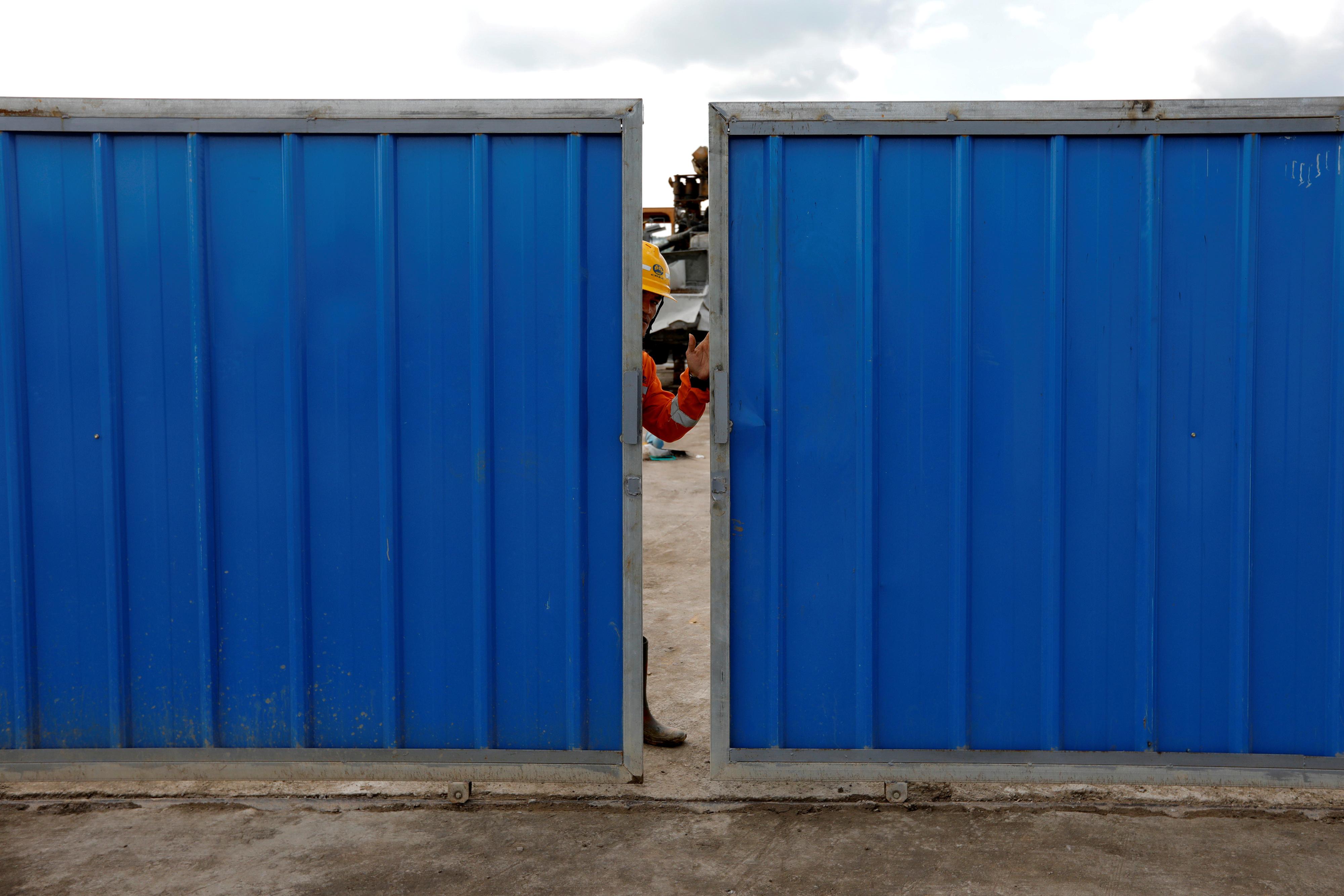 FILE PHOTO: A worker closes the gate at Walini tunnel construction site for Jakarta-Bandung High Speed Railway in West Bandung regency, West Java province, Indonesia, February 21, 2019. REUTERS/Willy Kurniawan/File Photo