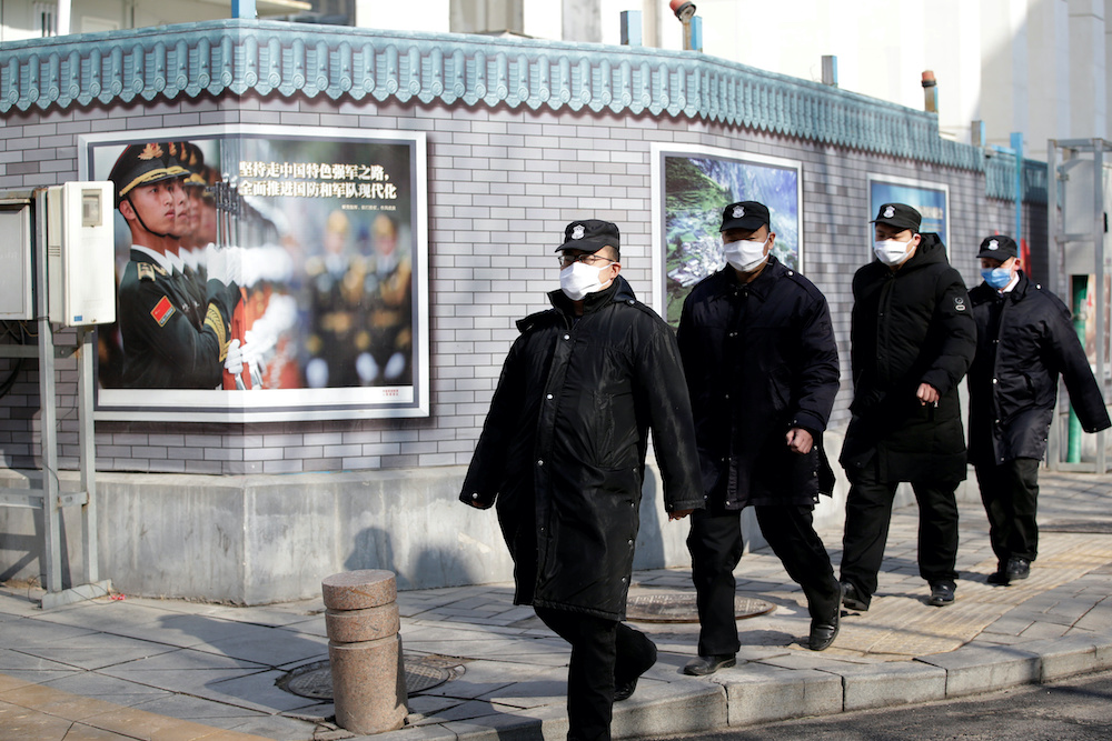 Security personnel wearing masks walk along the Financial Street in central Beijing, China, as the country is hit by an outbreak of the new coronavirus, February 3, 2020. u00e2u20acu201d Reuters picnn