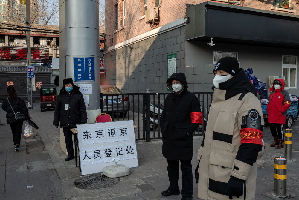 Security guards and volunteers wearing protective masks stand by the entrance of a residential area, where people are inspected for identification and temperature checks before entering the premises, in Beijing February 3, 2020. u00e2u20acu201d AFP pic