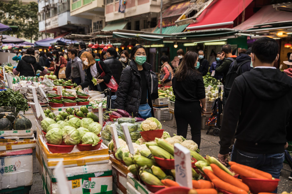 People wearing protective face masks shop at a fresh food market in Hong Kong February 9, 2020, as a preventative measure after a coronavirus outbreak which began in the Chinese city of Wuhan. u00e2u20acu201d AFP pic 