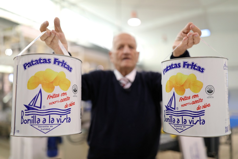 Owner Cesar Bonilla, 87, poses as he holds cans of potato chips during an interview with Reuters inside his Bonilla a la Vista factory in Arteixo, near Coruna, Spain February 17, 2020. u00e2u20acu201d Reuters pic 