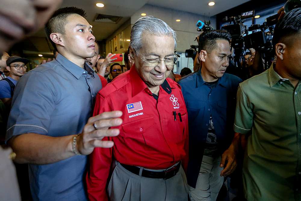 Bersatu chairman Tun Dr Mahathir Mohamad (in red shirt) leaves PBBM headquarters in Petaling Jaya February 23, 2020. u00e2u20acu201d Picture by Firdaus Latif
