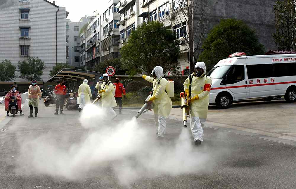 Volunteers in protective suits disinfect a residential compound in Taizhou, Zhejiang province, China January 30, 2020. u00e2u20acu201d China Daily pic via Reuters