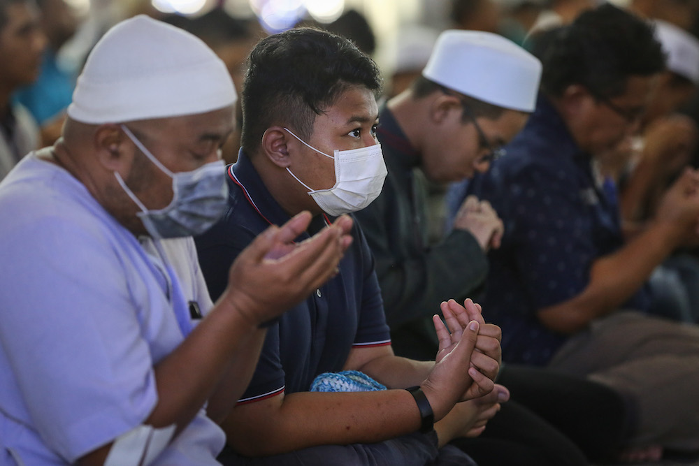 Worshippers wear protective mask as they pray during Friday prayers at Sultan Salahuddin Abdul Aziz Shah Mosque in Shah Alam March 13, 2020. u00e2u20acu201d Picture by Yusof Mat Isa