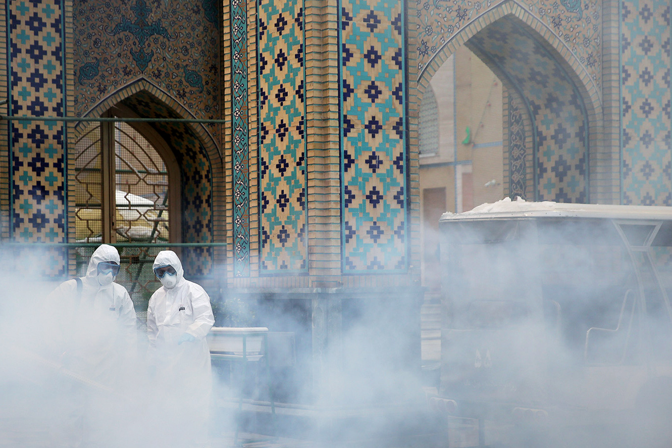 Members of a medical team spray disinfectant to sanitize outdoor place of Imam Reza's holy shrine, following the coronavirus outbreak, in Mashhad, Iran February 27, 2020. u00e2u20acu201d West Asia News Agency handout via Reuters