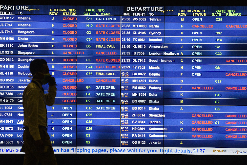 Passengers watching a departure screen at KLIA March 10, 2020. u00e2u20acu201d Picture by Miera Zulyana