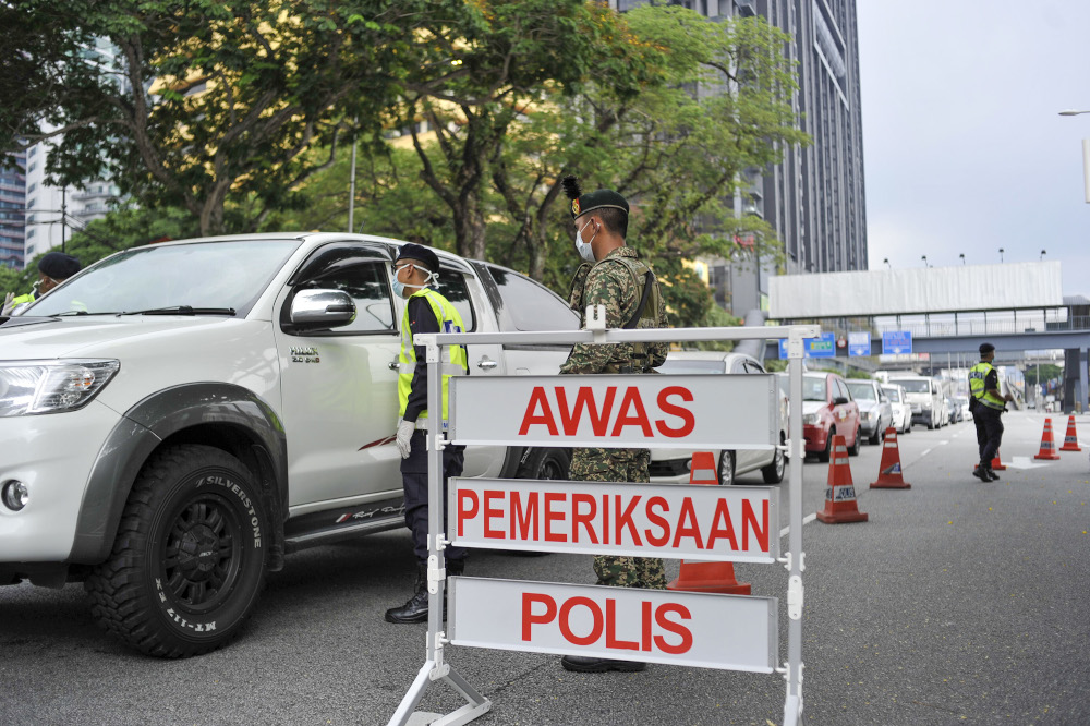 Malaysian Armed Forces and police personnel are seen at one of the roadblocks in Kuala Lumpur March 22, 2020. u00e2u20acu201d Picture by Shafwan Zaidon