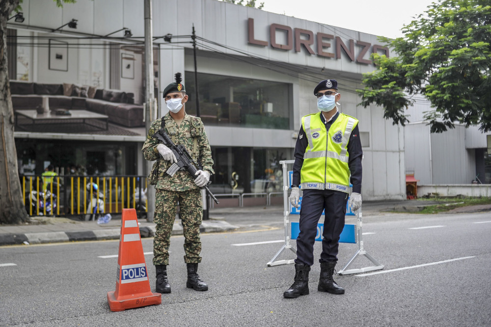 Malaysian Armed Forces and police personnel are seen at one of the roadblocks in Kuala Lumpur March 22, 2020. u00e2u20acu201d Picture by Shafwan Zaidon