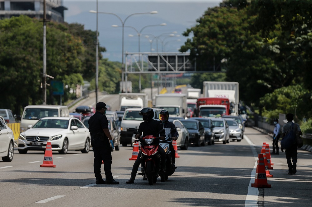 Police personnel are seen at a roadblock at Jalan Kuching in Kuala Lumpur March 28, 2020. u00e2u20acu201d Picture by Ahmad Zamzahuri