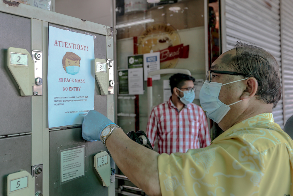 A sign stating u00e2u20acu02dcNo Face Mask No Entryu00e2u20acu2122 is seen outside a grocery store in Cheras March 22, 2020. u00e2u20acu201d Picture by Firdaus Latif 