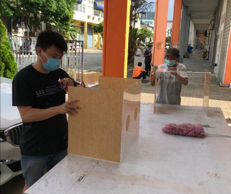 One of Simon Yapu00e2u20acu2122s workers assembling the aerosol boxes which doctors and nurses use as a protective layer. u00e2u20acu201d Picture courtesy of Simon Yap