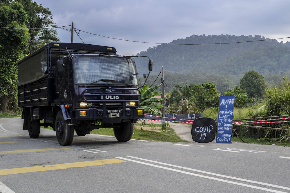 A police truck is seen entering the village during the enhanced movement control order (EMCO) in seven villages in Hulu Langat March 30, 2020. u00e2u20acu201d Picture by Shafwan Zaidon