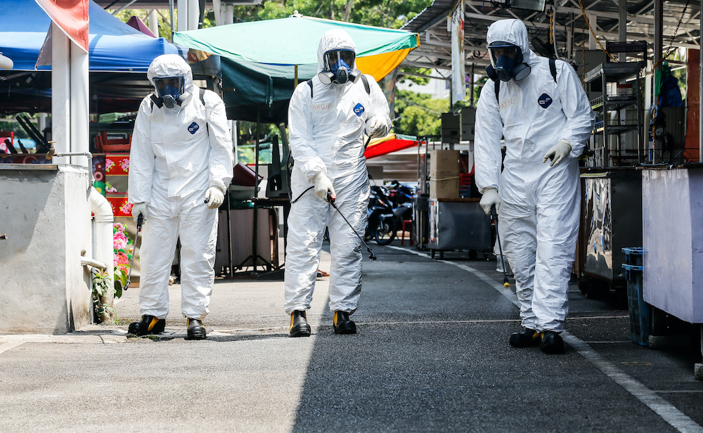 Fire and Rescue Department personnel carry out decontamination work at Tanjung Tokong March 30, 2020. u00e2u20acu201d Picture by Sayuti Zainudin