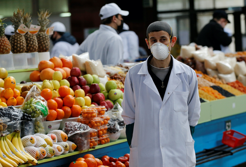 A vendor wearing a protective face mask following an outbreak of the coronavirus disease (Covid-19) waits for customers at a local food market, also known as bazaar, in Almaty, Kazakhstan March 21, 2020. u00e2u20acu201d Reuters pic