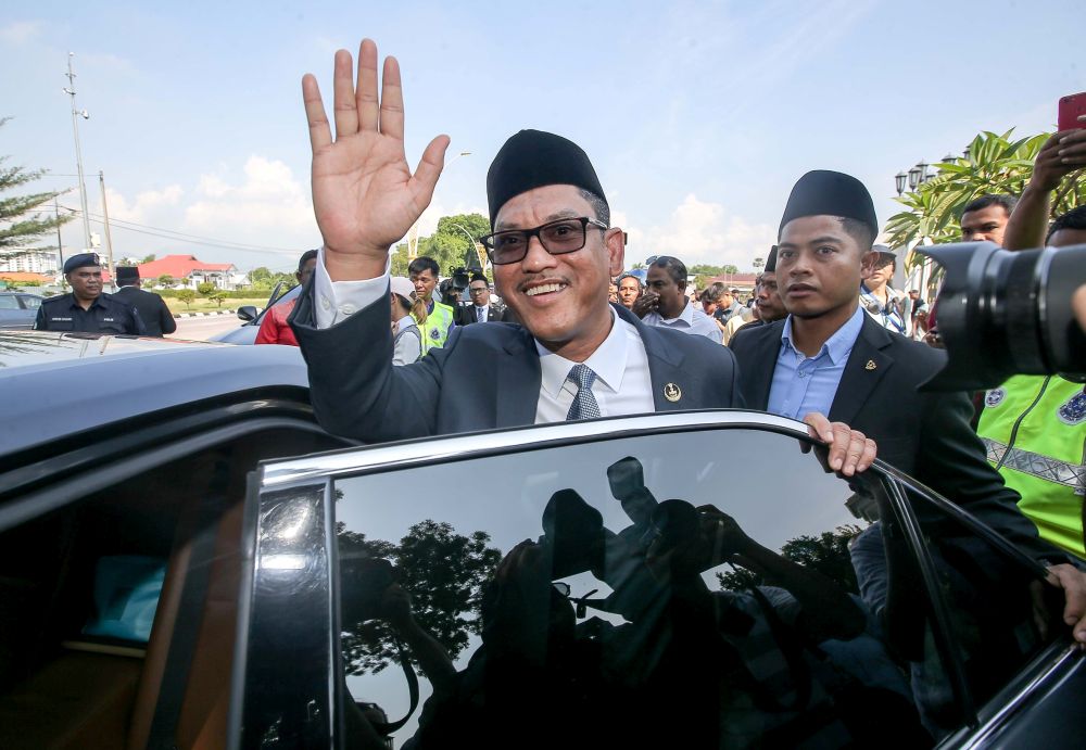 Datuk Seri Ahmad Faizal Azumu waves to reporters as he leaves Istana Kinta March 10, 2020. u00e2u20acu201d Picture by Farhan Najib
