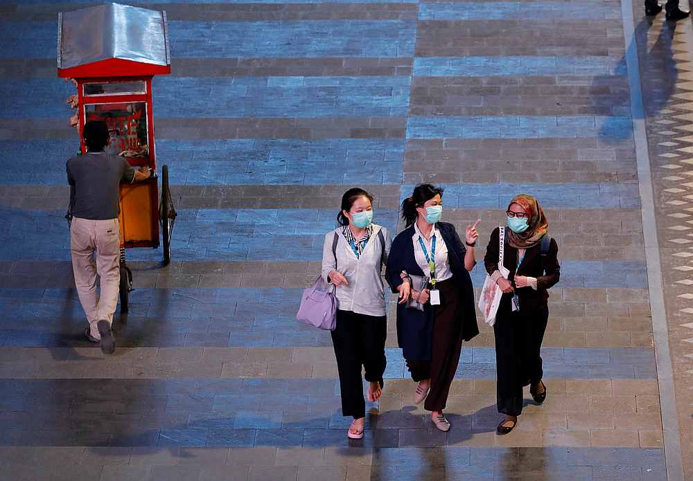 Women wearing face masks pass a vendor on a sidewalk of the main road after office hours, amid the spread of Covid-19 in Jakarta, Indonesia March 17, 2020. u00e2u20acu201d Reuters pic