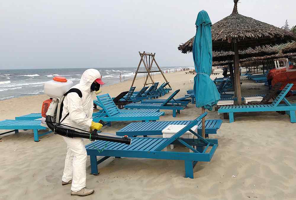 A health worker sprays disinfectants to protect against Covid-19 on a beach in Hoi An, Vietnam March 10, 2020. u00e2u20acu201d Reuters pic 