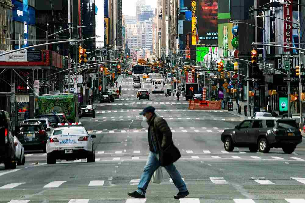 People walk around Times Square as Covid-19 outbreak continues in New York, March 22, 2020. u00e2u20acu201d Reuters pic