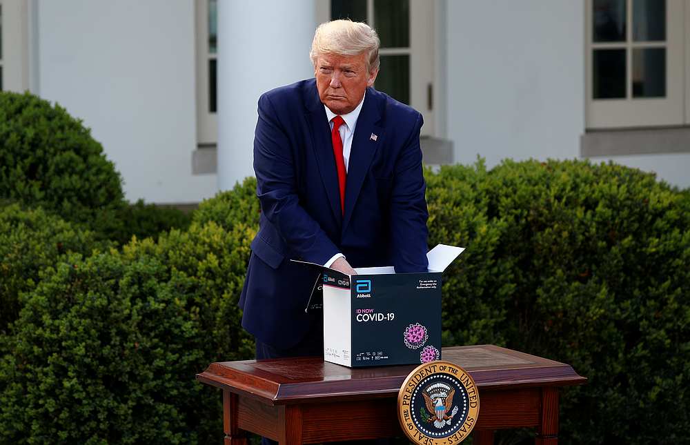 US President Donald Trump unboxes a coronavirus testing kit during the daily coronavirus response briefing in the Rose Garden at the White House in Washington March 30, 2020. u00e2u20acu201d Reuters pic