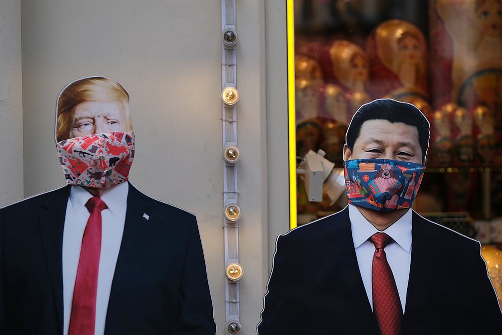 A view of cardboard cutouts of US President Donald Trump and Chinese President Xi Jinping, with protective masks widely used against Covid-19, near a gift shop in Moscow, Russia March 23, 2020. u00e2u20acu201d Reuters pic