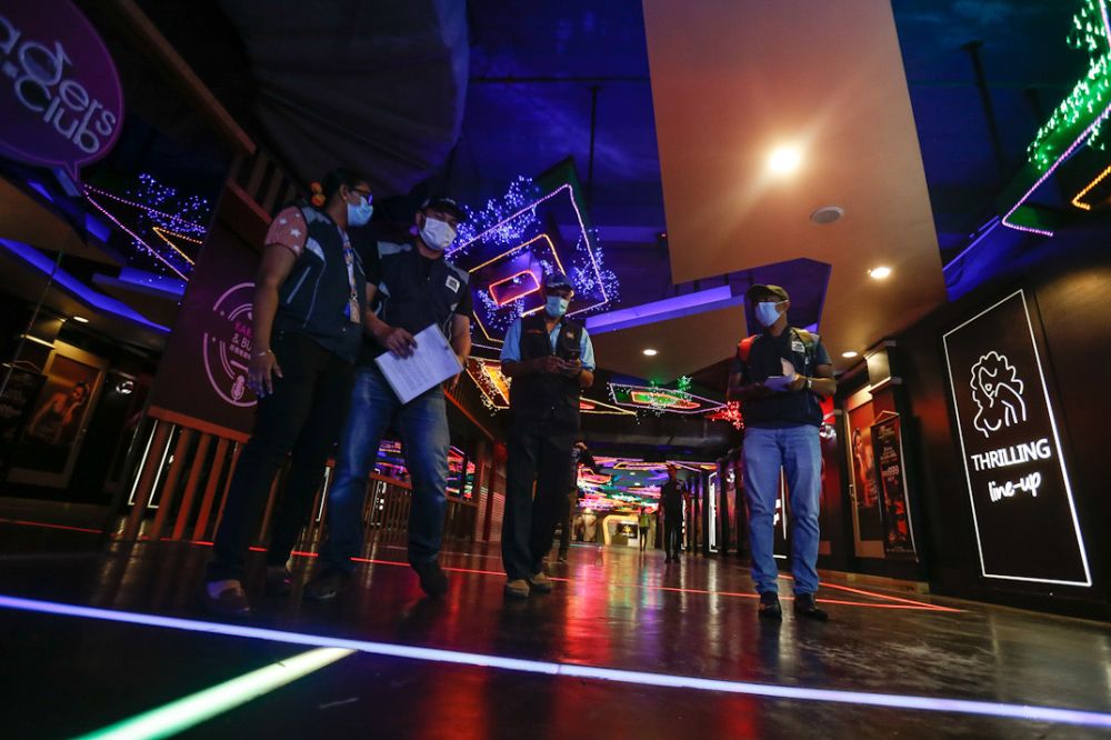 Penang Island City Council enforcement officers conduct spotchecks on pubs and eateries in George Town March 19, 2020. u00e2u20acu201d Picture by Sayuti Zainudinnn