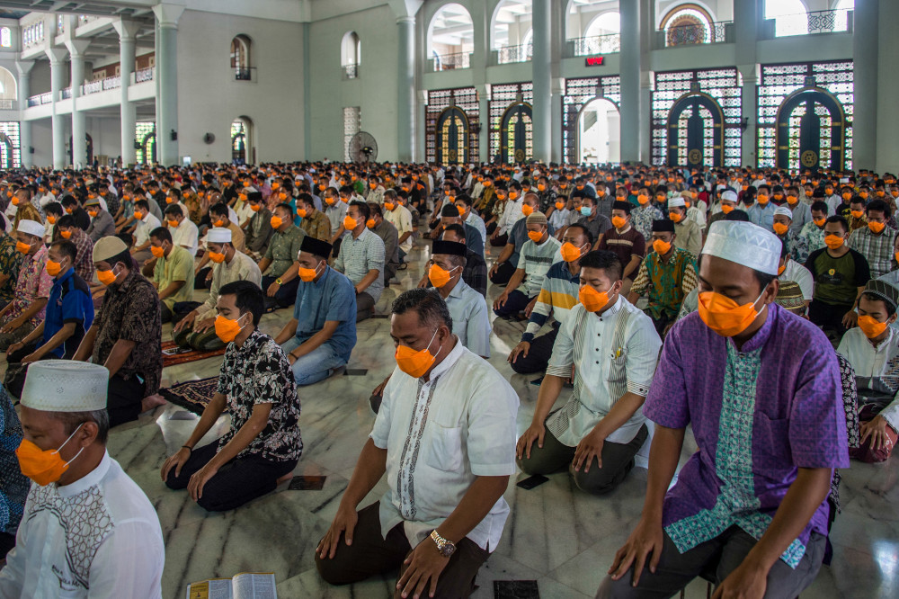 People wearing face masks as a precaution against the Covid-19 coronavirus outbreak attend obligatory Friday prayers at a mosque in Surabaya, East Java, March 20, 2020. u00e2u20acu201d AFP pic 